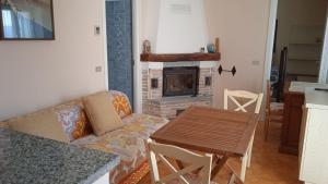 a living room with a couch and a fireplace at Villa Imperia in Imperia