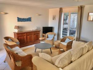a living room with a couch and chairs and a table at "Villa Llum i Mar", au coeur de Banyuls sur mer, 3 chambres avec climatisation, 2 SDB, garage,6 personnes, classée 3 étoiles in Banyuls-sur-Mer