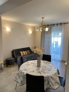a living room with a table and a couch at Appartement T3 centre ville in Bastia
