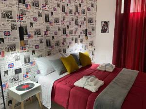 a bedroom with a bed with a wall with photos at Pontecorvo Naples Apartament in Naples +37 photos