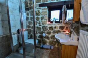 ein Bad mit einer Dusche, einem Waschbecken und einem WC in der Unterkunft Filanthi in Kato Trikala Korinthias