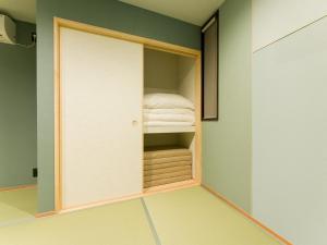 a room with a closet with a bed in it at Rakuten STAY VILLA Kamogawa Building C with Terrace and sauna Capacity of 10 persons in Kamogawa