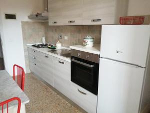 a kitchen with a white refrigerator and a stove at L'OZioRinco in Florence