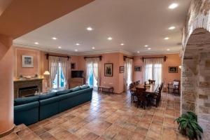 a living room with a blue couch and a table at Pantaleon House in Ano Syros