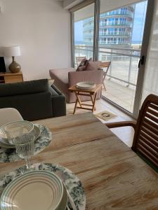 a living room with a table with plates on it at Chez Ocean Plaza in Figueira da Foz