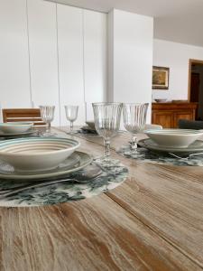 a dining room table with plates and glasses on it at Chez Ocean Plaza in Figueira da Foz