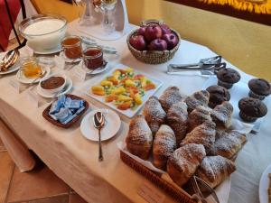 a table with a bunch of pastries and fruit on it at Meublè Evoè in Montepulciano
