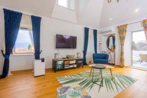 a living room with a table and a tv at Apartment Oskar in Supetar