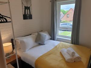 um quarto com uma cama com duas toalhas em Marlow's Emerald 3 Bedroom House em Marlow