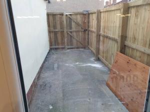 an empty room with a wooden fence and a bench at Grange Villas Diamond nr Chester le Street 3 Bed in Chester-le-Street