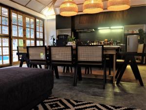 a dining room with a table and some chairs at TheMalkohaVilla in Umsning