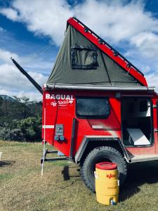 a red truck with a tent on top of it at BAGUAL TRAILER in Ushuaia