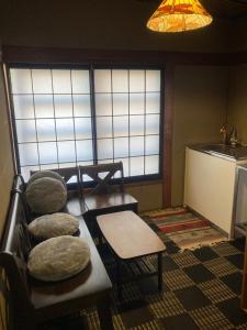 a room with chairs and a table and windows at 揚羽屋 小諸駅徒歩2分 1日1組限定 ひとりでも泊まれます Agehaya Historical house Center of the town 2minutes walk from Komoro station in Komoro