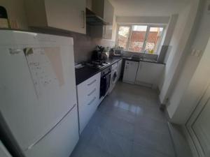 a kitchen with white appliances and a white refrigerator at South Shield's Hidden Gem Amethyst 3 Bedroom House in South Shields