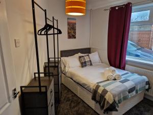 a bedroom with a bed with two teddy bears on it at Grange Villa Amethyst 3 Bed House in Chester-le-Street