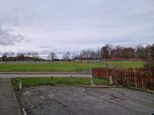 a parking lot with a fence and a field at Grange Villa Amethyst 3 Bed House in Chester-le-Street