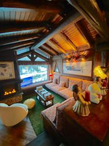 a living room with a couch and a fireplace at Baita LE SERE in Sestriere