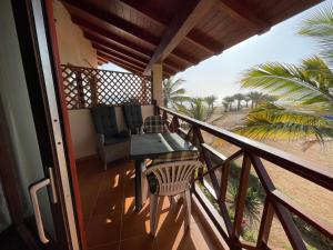 a balcony of a house with a table and chairs at studio's Porto Antigo 2 in Santa Maria