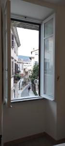 an open window with a view of a city street at La Casetta di Cecilia in Tivoli