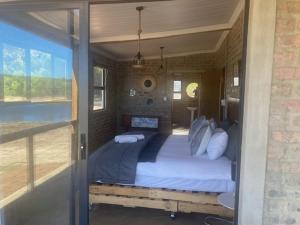 a bedroom with a large bed in a house at De Poort Cottage in Bredasdorp