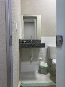 a bathroom with a sink and a toilet at Morada do Lago in Palmas +55 photos