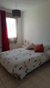 1 dormitorio con 1 cama con edredón de flores en Les soleiades en Béziers
