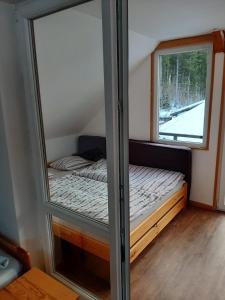a room with two beds in a room with a window at Rulfik in Hinterberg