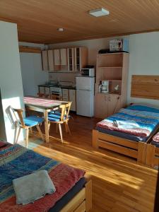 a room with a kitchen and a table and chairs at Rulfik in Hinterberg +34 photos