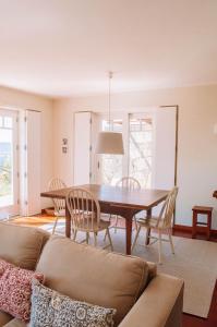 a living room with a couch and a table and chairs at Just like Home - Number 8 em Quinta das Mineirinhas in Vila Nova de Cerveira