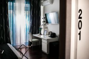 TV a/nebo společenská místnost v ubytování Relais Circo Massimo