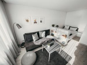 a living room with a couch and a table at Marijampole Apartment with FREE Parking in Marijampolė