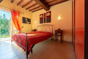 a bedroom with a bed with a red bedspread at Villetta San Martino in Portoferraio