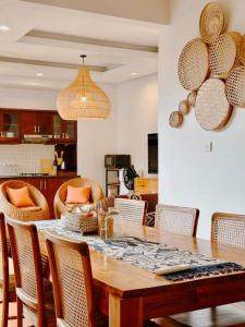 a dining room with a wooden table and chairs at Villa Sriwedari - Seminyak in Seminyak