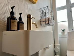 two bottles of wine sitting on top of a sink at Hotel Strandly Skagen in Skagen