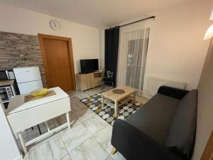 ein Wohnzimmer mit einem Sofa und einem Tisch in der Unterkunft Apartment Adam & Eva in Piešťany
