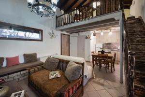 a living room with a couch and a table at Chalet Renata 1 Livadi Arachovas in Kalívia