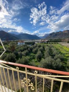 a view from a balcony with mountains in the background at Thassa Beach Apartment No6 (with mountain view) in Leonidio +10 photos