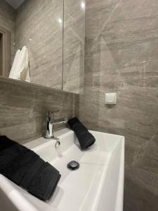 a bathroom with a white sink and a mirror at EmilyApartments 1 in Chrysoupolis