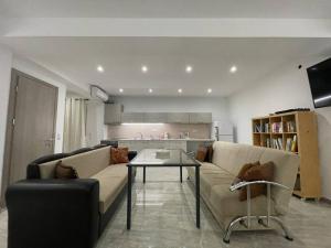 a living room with a couch and a table at EmilyApartments 1 in Chrysoupolis