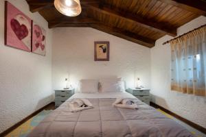 a bedroom with a large bed with towels on it at Chalet Renata 2 Livadi Arachovas in Kalívia