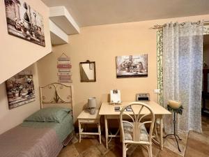 a bedroom with a desk and a bed and a desk and chair at Villa Adriana House - alloggio turistico ID 18021 in Tivoli