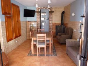 cocina y sala de estar con mesa y sofá en Vivienda Vacacional La Cantera, en Cangas de Onís