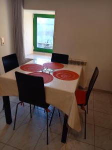 a dining room table with four chairs around it at Ile breizh in Ploubezre