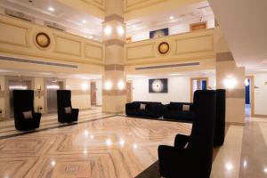 a lobby with couches and chairs in a building at سويتس المقام in Makkah