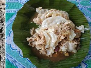 a green plate of food on a table at Jolits Ecogarden Integrated Farm in Batuan