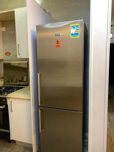 a stainless steel refrigerator in a kitchen at Heliopolis Residence Shrouk city Cairo in Madīnat ash Shurūq