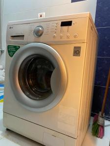 a washing machine with a brush on top of it at Heliopolis Residence Shrouk city Cairo in Madīnat ash Shurūq