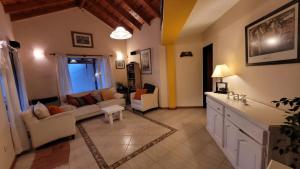 a living room with a couch and a table at El Patio del Aromo in Puerto Madryn