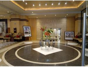 a lobby with a table with flowers on it at Michelangelo Towers 0801 in Johannesburg
