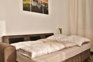 a bed in a room with a vase on it at Ferienwohnung-Weinstadt in Weinstadt